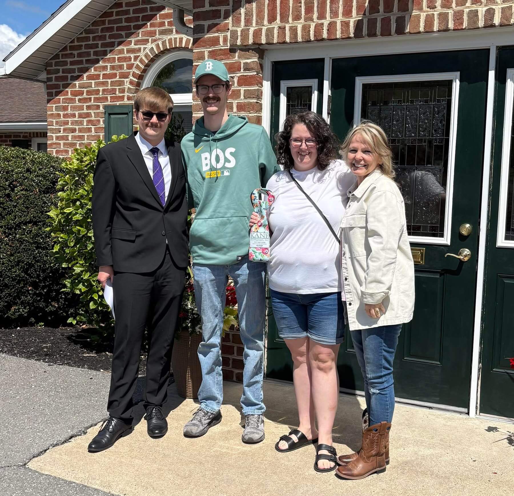 New homeowners celebrate outside the Kane Mortgage office.
