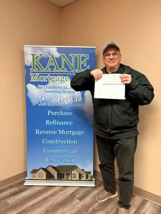 A client holds a document in the offices of Kane Mortgage, Inc.