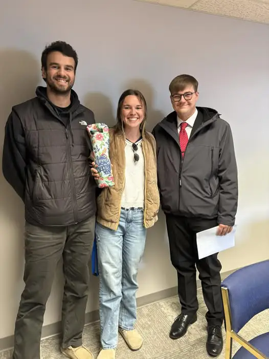 A couple poses with Keegan Kerstetter of Kane Mortgage, Inc.